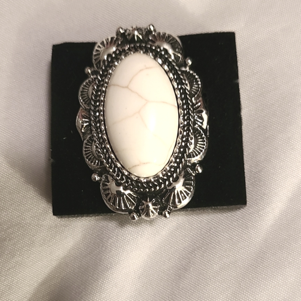Silver Ring with white crackle stone in the center.